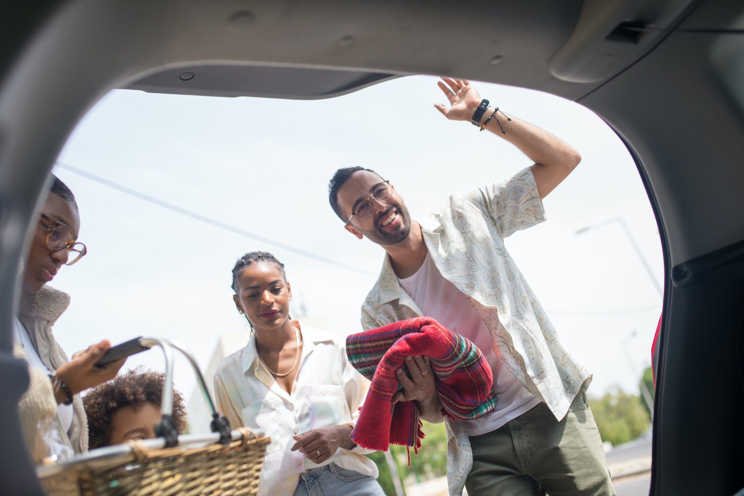 A secured car loan can be life-changing. A family looks in the trunk of a car.